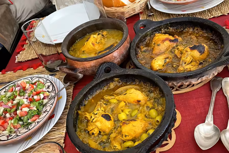 Finished chicken tagines and a salad ready on the family table