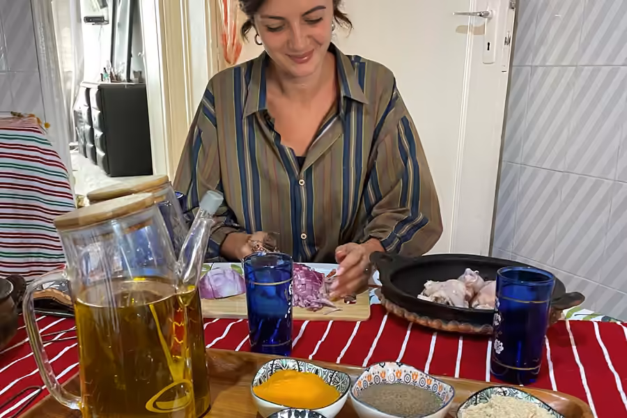 A guest preparing spices and olive oil for the cooking class