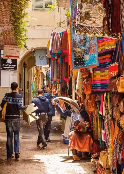 A narrow street of the Tangier medina lined with textile shops