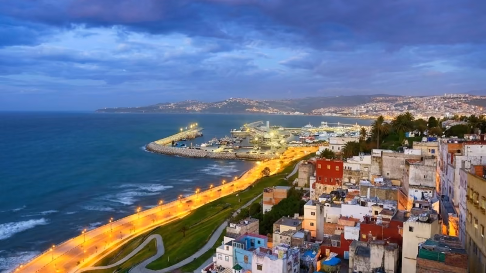 The lights of Tangier along the bay at dusk, seen from the Marshan