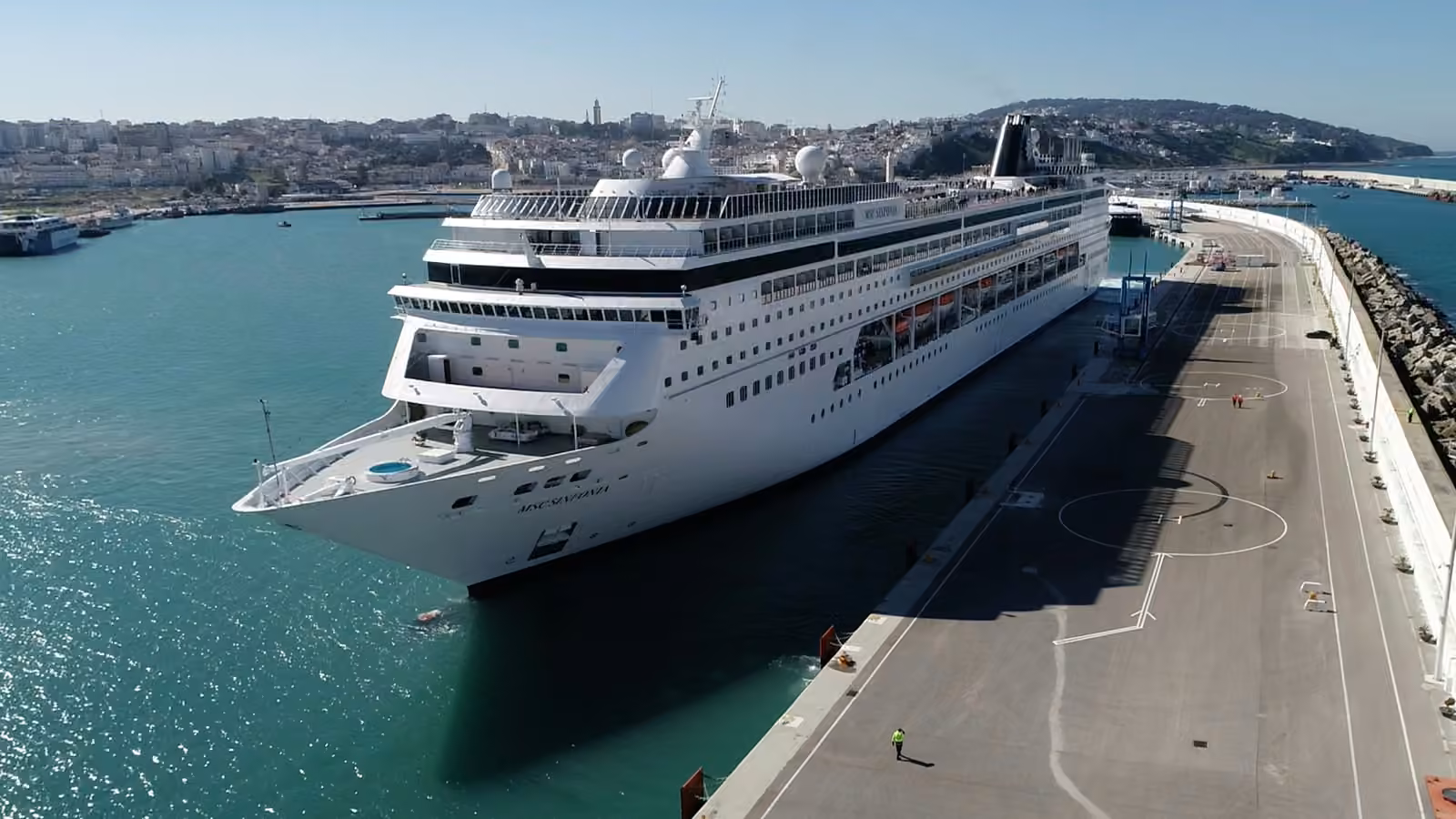 MSC Sinfonia cruise ship moored at the Tanger Ville cruise quay, with the medina and hills of Tangier behind